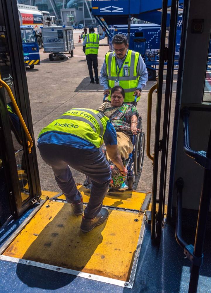 Passenger boarding a shuttle bus by wheelchair ramp