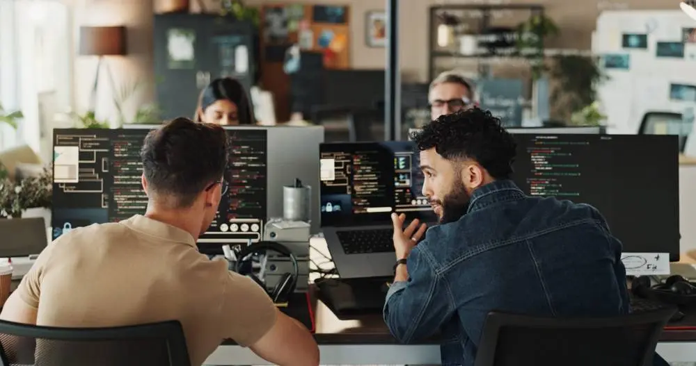 Integration specialist helping a customer at a computer